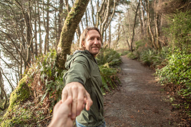 istock Follow me to concept, young man leading girlfriend to forest path 1191208528