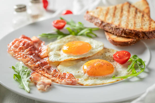 istock Closeup of breakfast with toast, bacon, eggs and tomatoes 1191209641