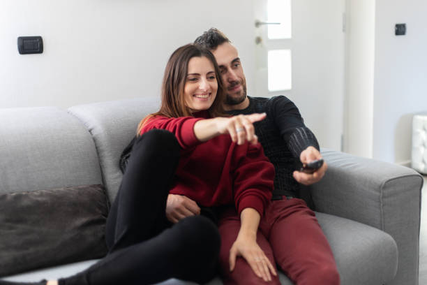 istock Couple watching a movie together on a couch 1191209743