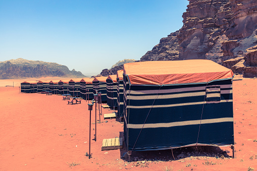 Red sand desert and Bedouin camp at sunny summer day in Wadi Rum, Jordan. Middle East.