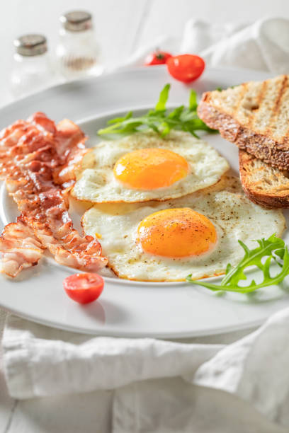 istock Homemade breakfast with toast, bacon, eggs and tomatoes 1191211717