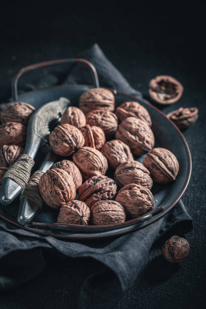 istock Tasty walnuts with with old metal nutcracker 1191211855