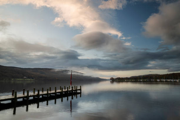istock Stuning Autumn Fall sunrise landscape over Coniston Water with mist and wispy clouds 1191212861