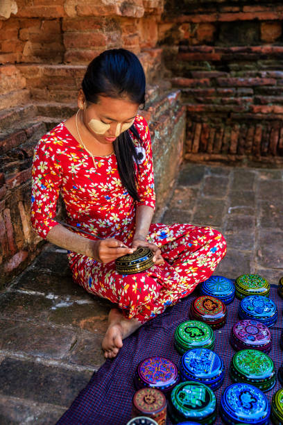 Young Burmese girl making a lacquerware in Bagan, Myanmar