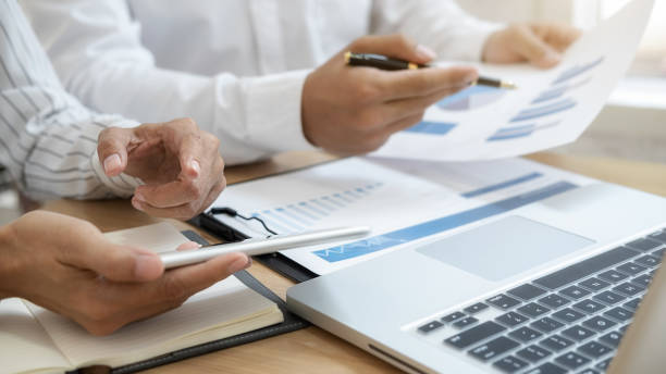 istock Business team brainstorming and discussing with financial data and report graph. Teamwork meeting working concept. 1191214349