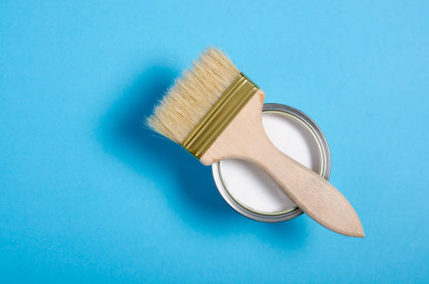 istock Open can with white paint and brush 1191215712