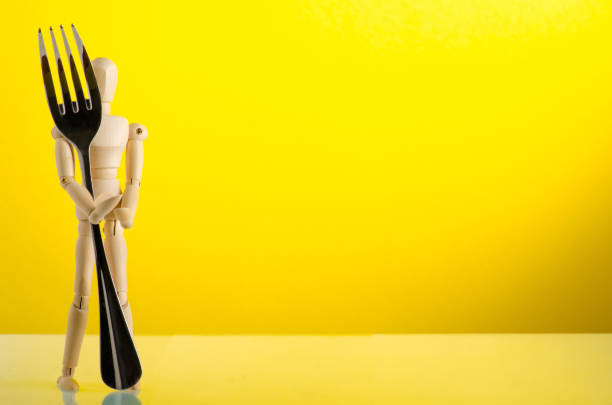 istock wooden man figure with fork 1191215737
