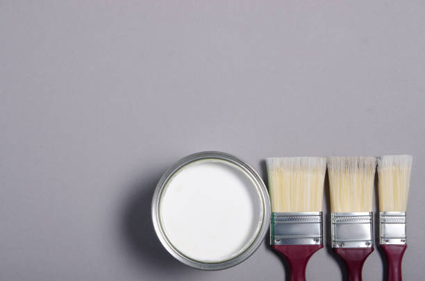 istock Open can with white paint and brush 1191215767