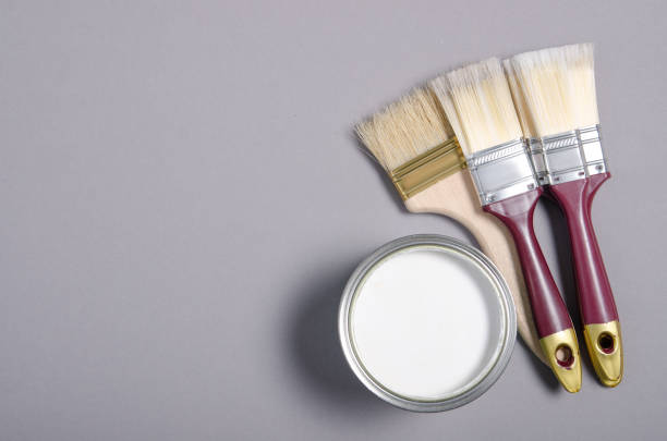 istock Open can with white paint and brush 1191215787