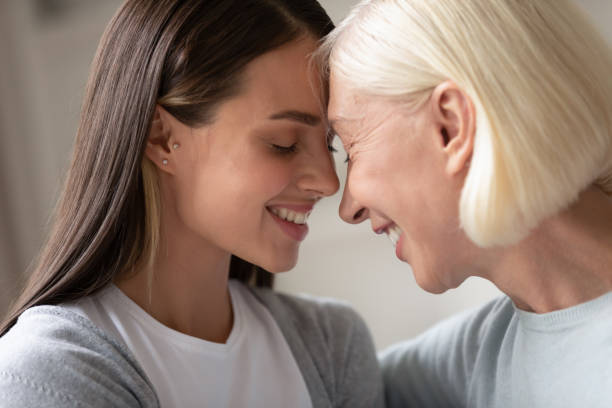 istock Close up faces old mother young daughter touch foreheads 1191216480