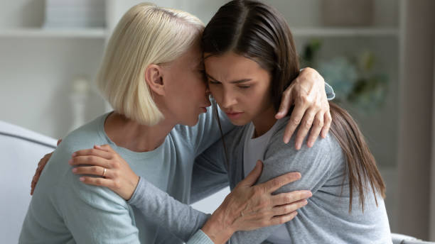 istock 50s mother hugs calms grownup daughter telling words supporting her 1191216487