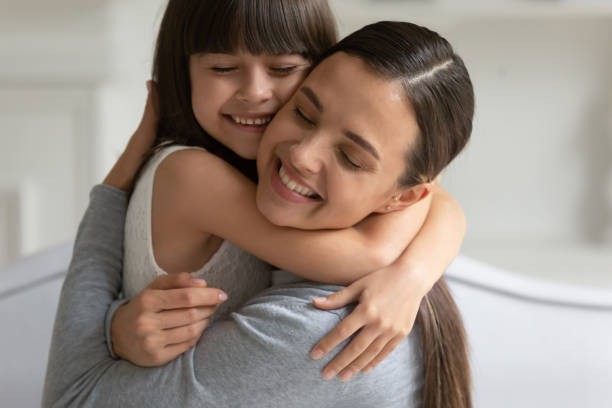 istock Mother cuddle daughter feeling love and connection closeup view 1191216502