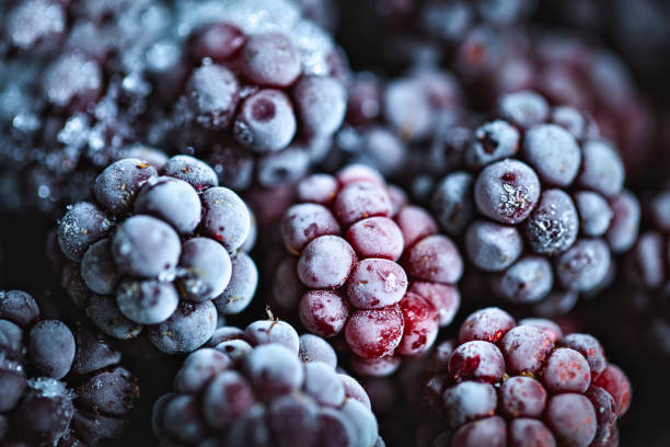istock Frozen blackberries on a wooden table. Horizontal. Top view. 1191217130