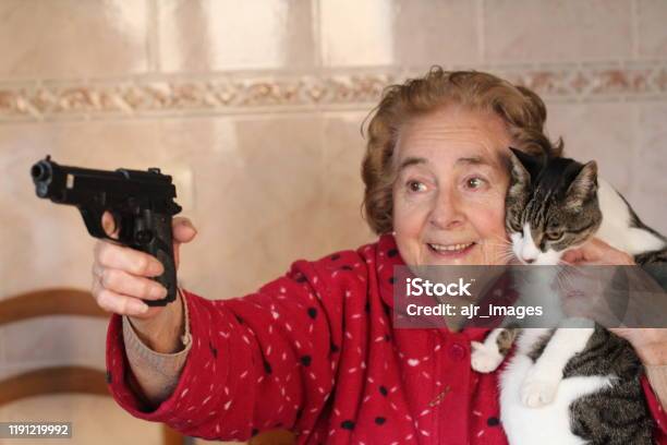 Hilarious Lady Protecting Her Cat Stock Photo - Download Image Now - Senior Adult, Women, Domestic Cat