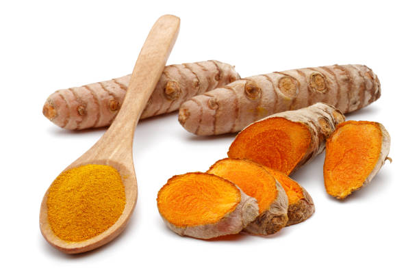 istock Fresh turmeric with slices and curcuma powder in a spoon 1191221132