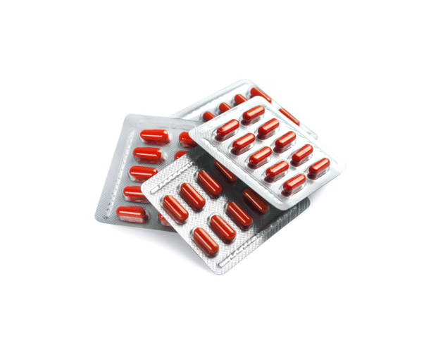 istock Red pill capsules in blister packs isolated on white background with clipping path 1191221145