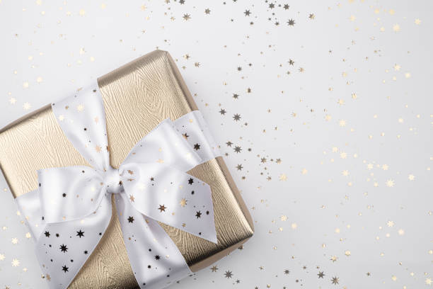 istock Gold gift box with a white ribbon. 1191223546
