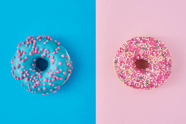 istock Two donuts on a pastel pink and blue background. Minimalism creative food composition. Flat lay style 1191224664