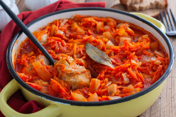 istock Pollock in a tomato marinade with onions and carrots in a round shape, selective focus 1191225879