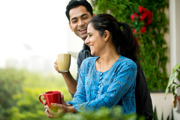 istock Happy couple drinking coffee at balcony 1191226780