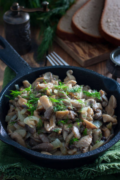 istock Fried oyster mushrooms in a cast-iron pan, selective focus 1191227963