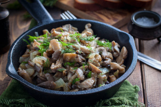 istock Fried oyster mushrooms in a cast-iron pan, selective focus 1191227979
