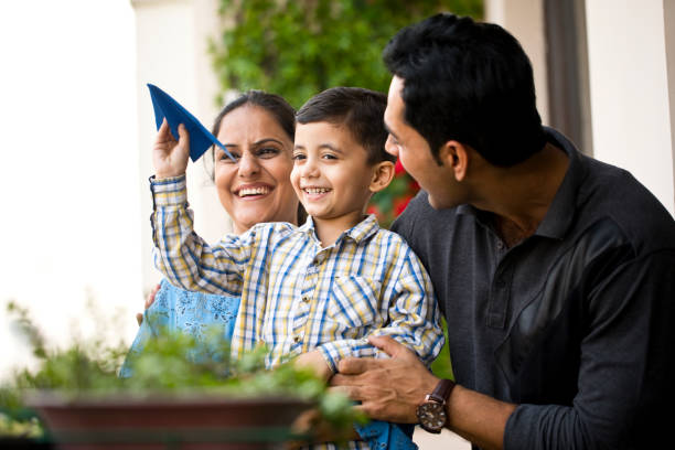 istock Indian family playing with paper airplane 1191228337