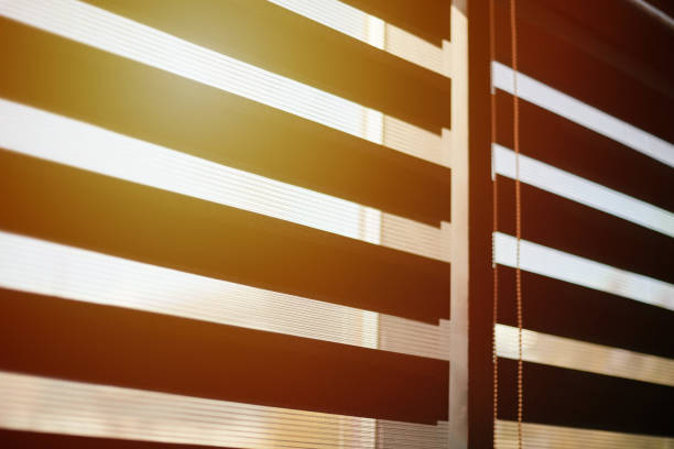 istock Office blinds. Sunlight through modern fabric blinds. Office meeting room lighting range control. 1191230102