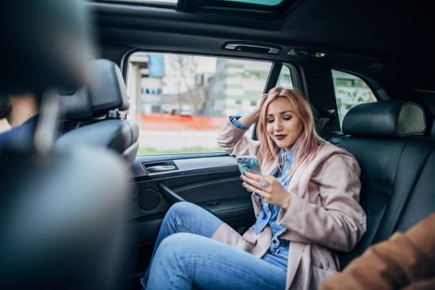 istock Woman is using smart phone in a car 1191231420