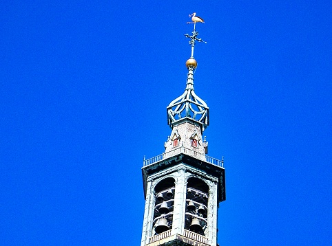 The bell tower of Saint James church in The Hague Netherlands against blue sky