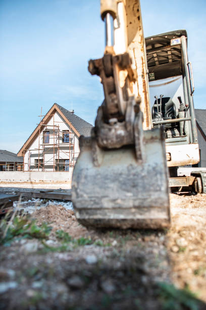 istock Excavator and new built houses 1191231601