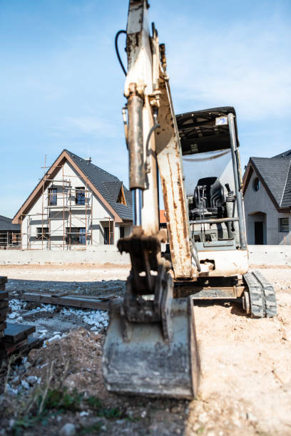 istock Excavator and new built houses 1191231648
