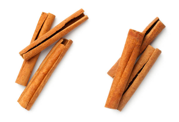 cinnamon sticks isolated on white background - cinnamon imagens e fotografias de stock