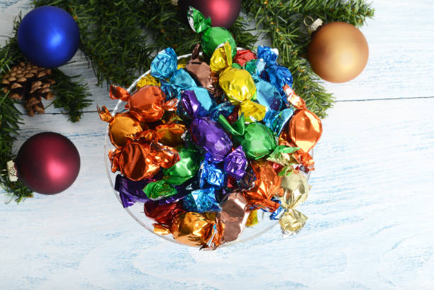 top view christmas candy in a bowl with ornaments