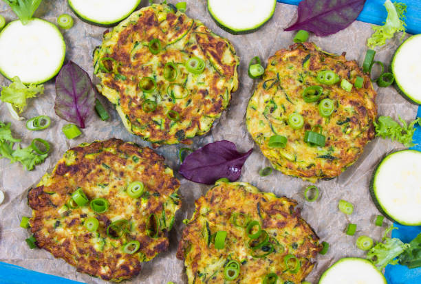 istock Zucchini pancakes with chives on a wooden table. 1191235615