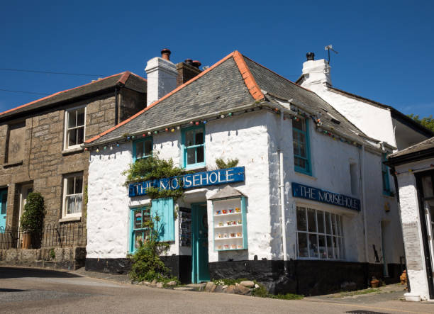 Mouse hole, Cornwall, UK - June 22, 2018.  The popular tourist destination of Mousehole in Cornwall, UK showing the traditional gift shop known as The Mousehole