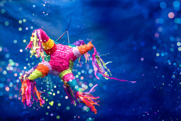 Mexican piñata party Mexican piñata party hanging blue and green background with bright multicolored celebrating birthday, Christmas, party, party songs, star and donkey figure, family fun ass horse family photos stock pictures, royalty-free photos & images