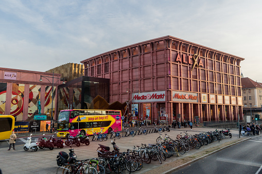 Alexa Shopping Center in Berlin, Germany. Tour buses, bicycle rentals line the busy street