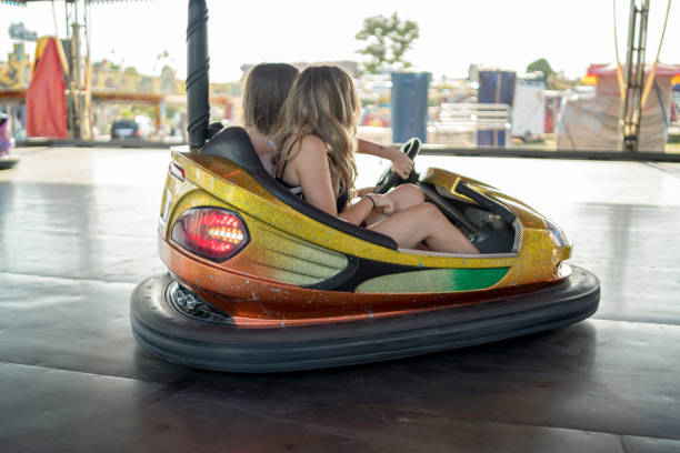 istock Happy girlfriends driving a bumper car and smiling 1191239284