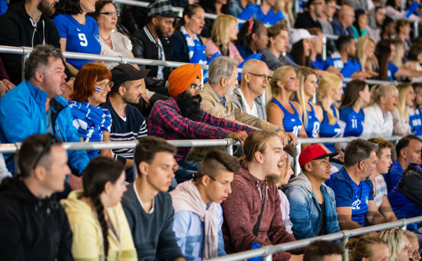 istock Cheering Fans With Blue Banging Thundersticks 1191240075