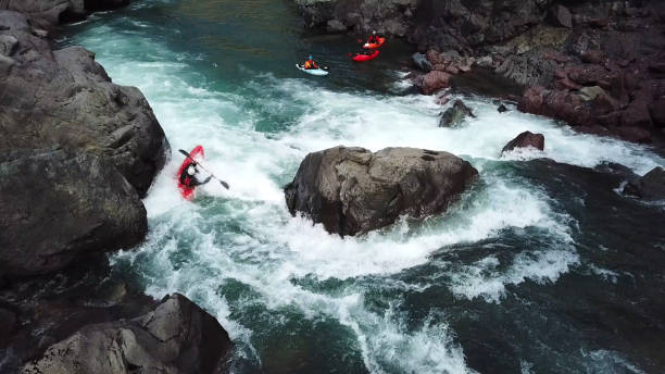 istock White water kayaker paddles down river to meet friends 1191240247