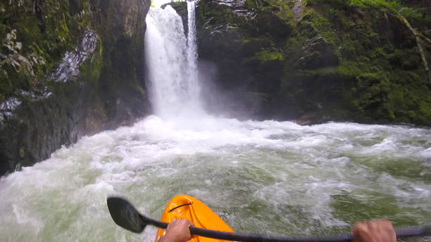 istock White water kayaker paddles toward waterfall 1191240443