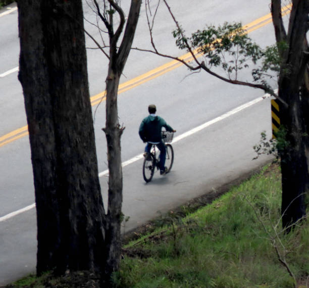 istock Man on a bike seen from afar over elevated shot 1191240519