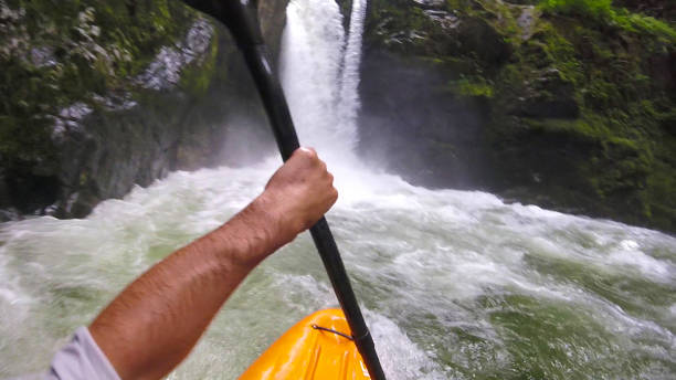 istock White water kayaker paddles toward waterfall 1191241098