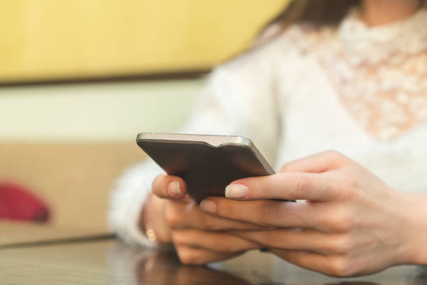 istock Woman using smart phone at cafe 1191242644