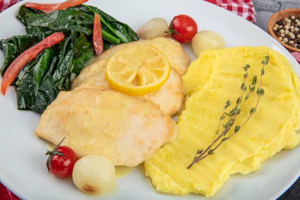 istock Roast chicken fillet and vegetables. Chicken baked with mashed potatoes, lemon and herbs spinach. 1191242733