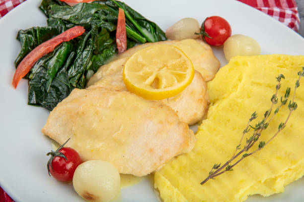 istock Roast chicken fillet and vegetables. Chicken baked with mashed potatoes, lemon and herbs spinach. 1191245443