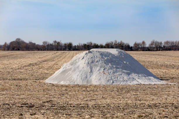 Pile of pulverized agricultural lime, limestone, fertilizer in soybean field stubble waiting fall application landscape, copy space apply fertilizer stock pictures, royalty-free photos & images