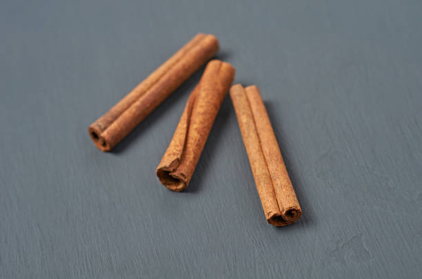 istock Three flavour cinnamon sticks lies on dark scratched desk on kitchen. Close-up 1191248760