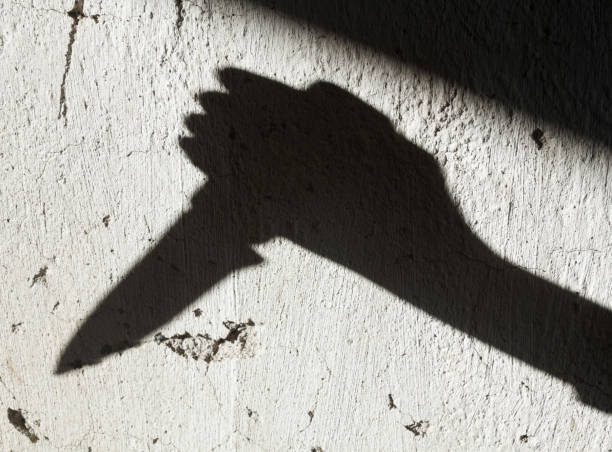 istock Shadow of the hand holding a knife 1191249388